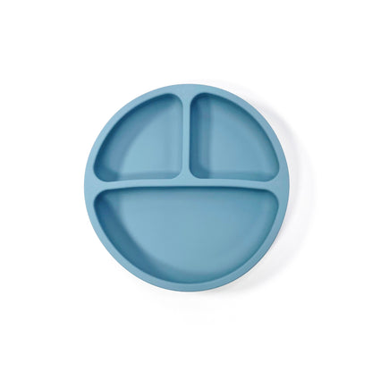 An ocean blue silicone children’s section place with suction cups on the base. View from above.