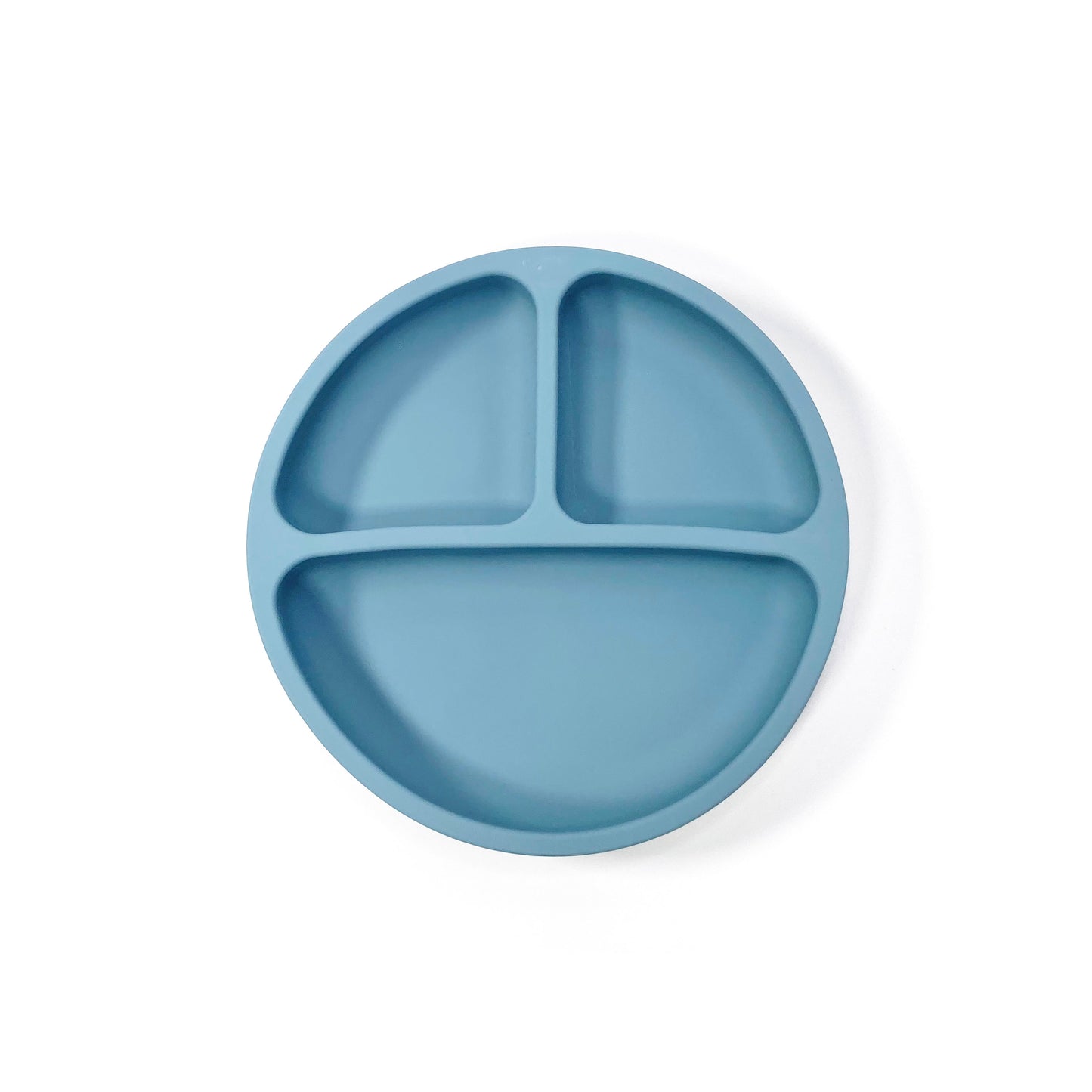 An ocean blue silicone children’s section plate with suction cups on the base. View from above.