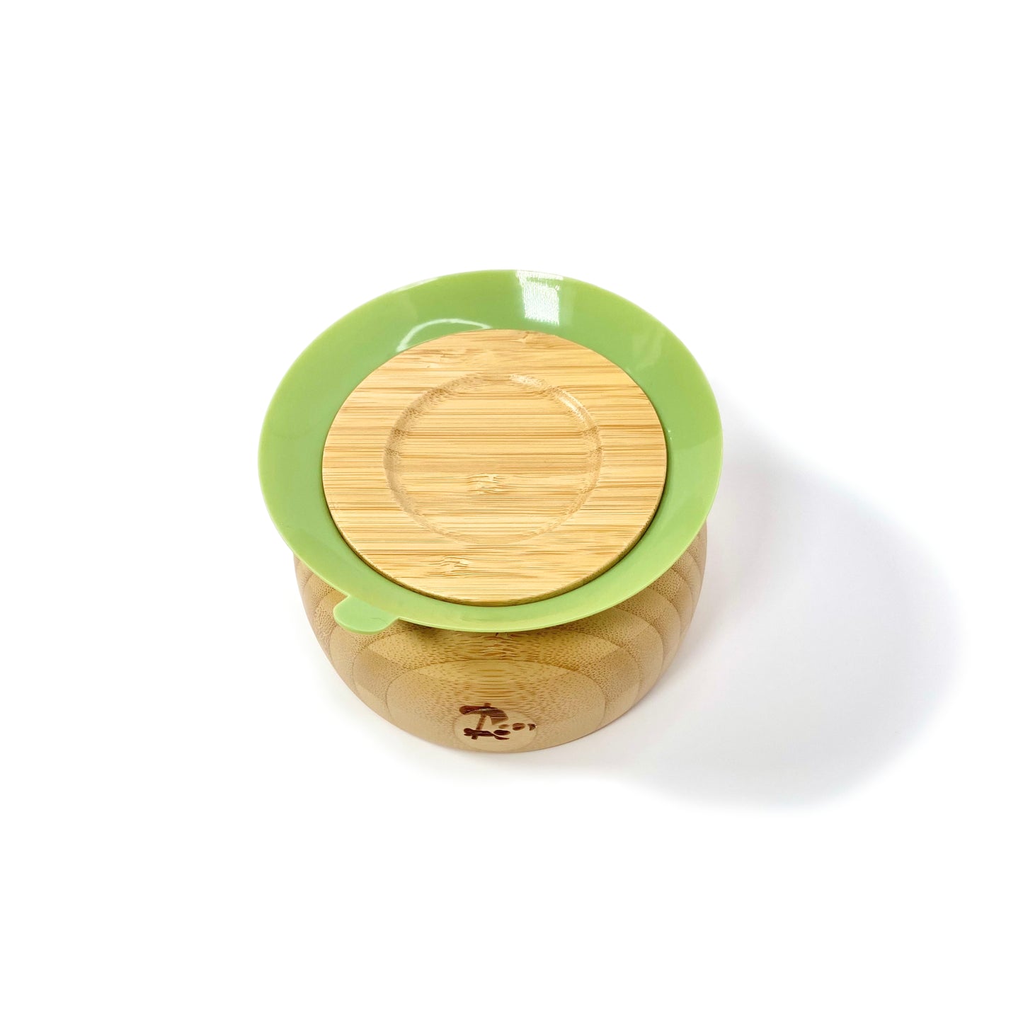A children’s bamboo bowl with an olive green silicone suction ring. Image shows the underside of the bowl, featuring the silicone suction ring.