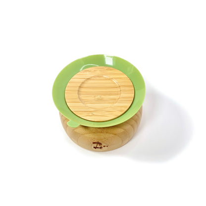 A children’s bamboo bowl with an olive green silicone suction ring. Image shows the underside of the bowl, featuring the silicone suction ring.