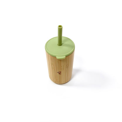 A children’s bamboo drinking cup, with an olive green silicone lid and matching straw. View shows the cup with lid and straw attached.