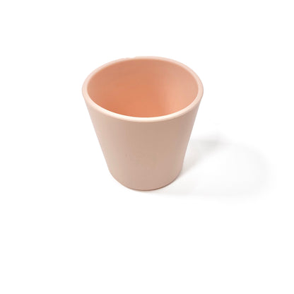 A peachy pink silicone children’s drinking cup.