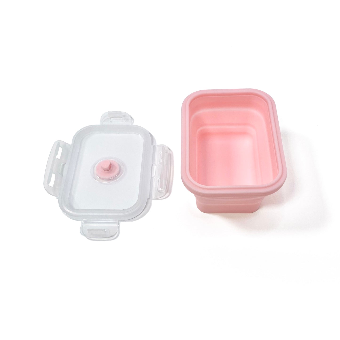 A collapsible pink rectangular silicone food storage tub with lid. Side view with the tub fully expanded and the lid removed.