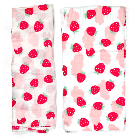 A set of two muslin baby blankets, one light swaddle blanket and one thick buggy blanket, with pink strawberry designs.