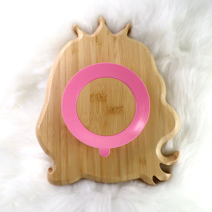 A children's bamboo section plate with a princess design, pink colour silicone suction ring and matching pink bamboo and silicone cutlery. Back view.
