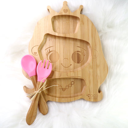 A children's bamboo section plate with a princess design, pink colour silicone suction ring and matching pink bamboo and silicone cutlery. Front view.