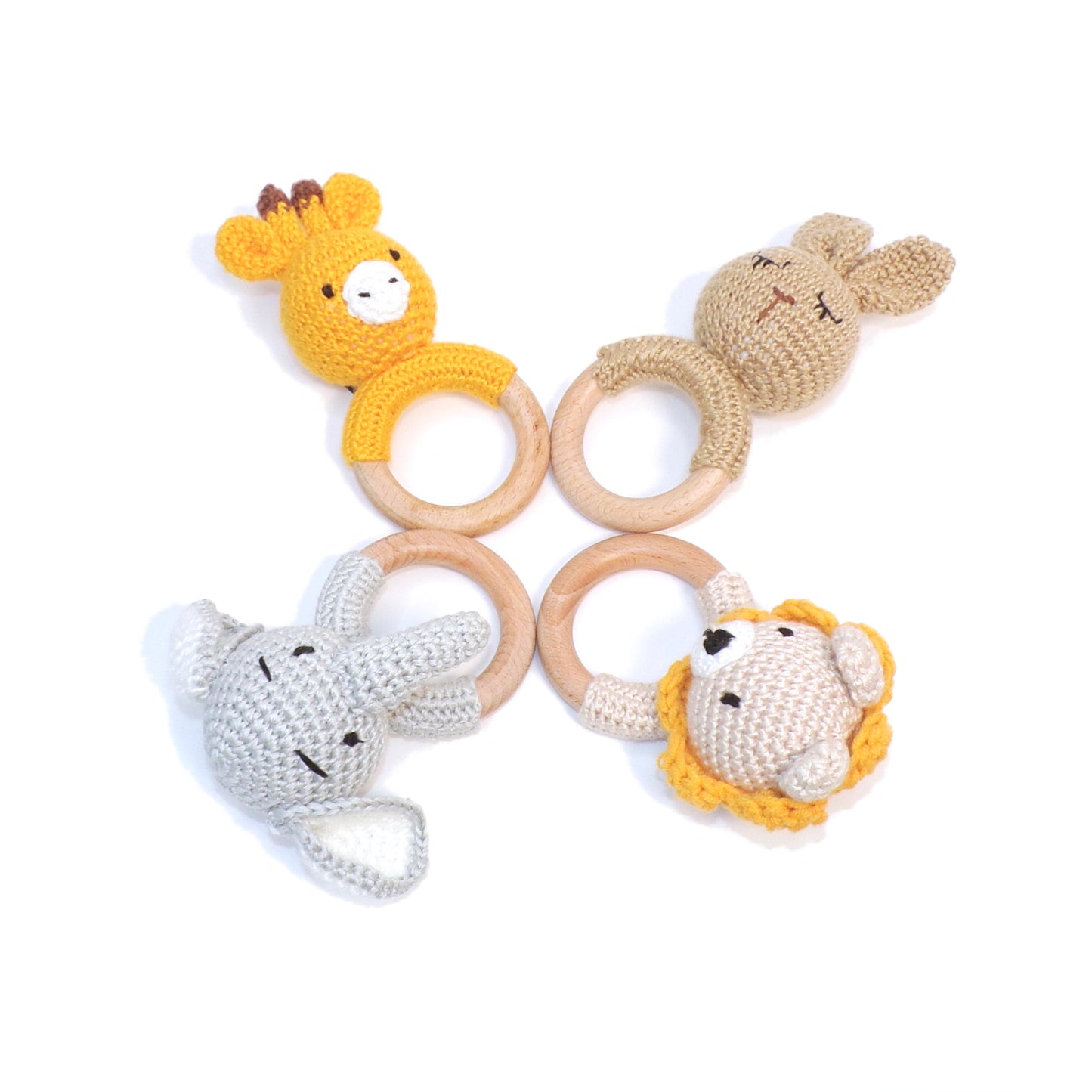 Baby rattles in rabbit, giraffe, elephant and lion designs, made from wool and bamboo.