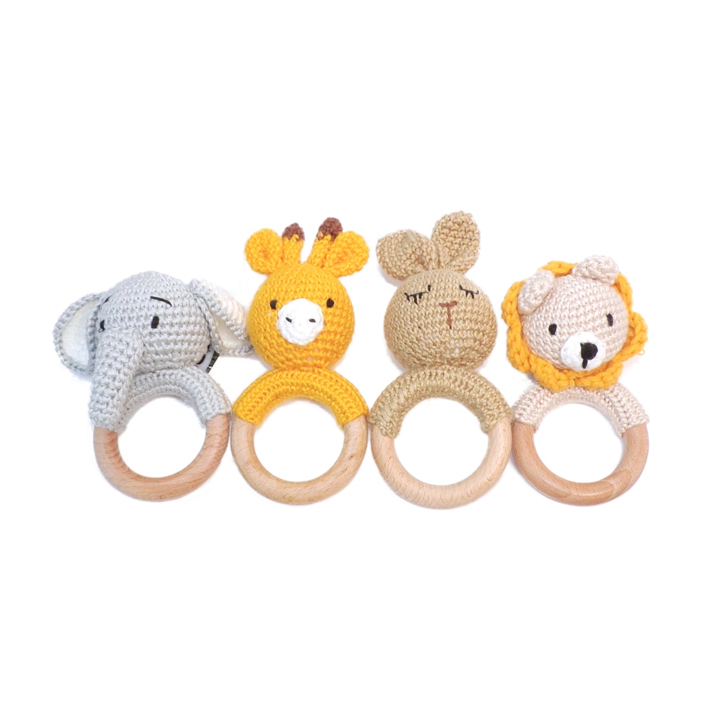Baby rattles in rabbit, giraffe, elephant and lion designs, made from wool and bamboo.