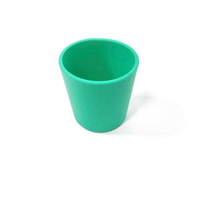 A seafoam green silicone children’s drinking cup.