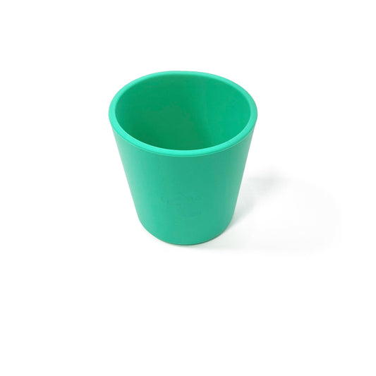 A seafoam green silicone children’s drinking cup.