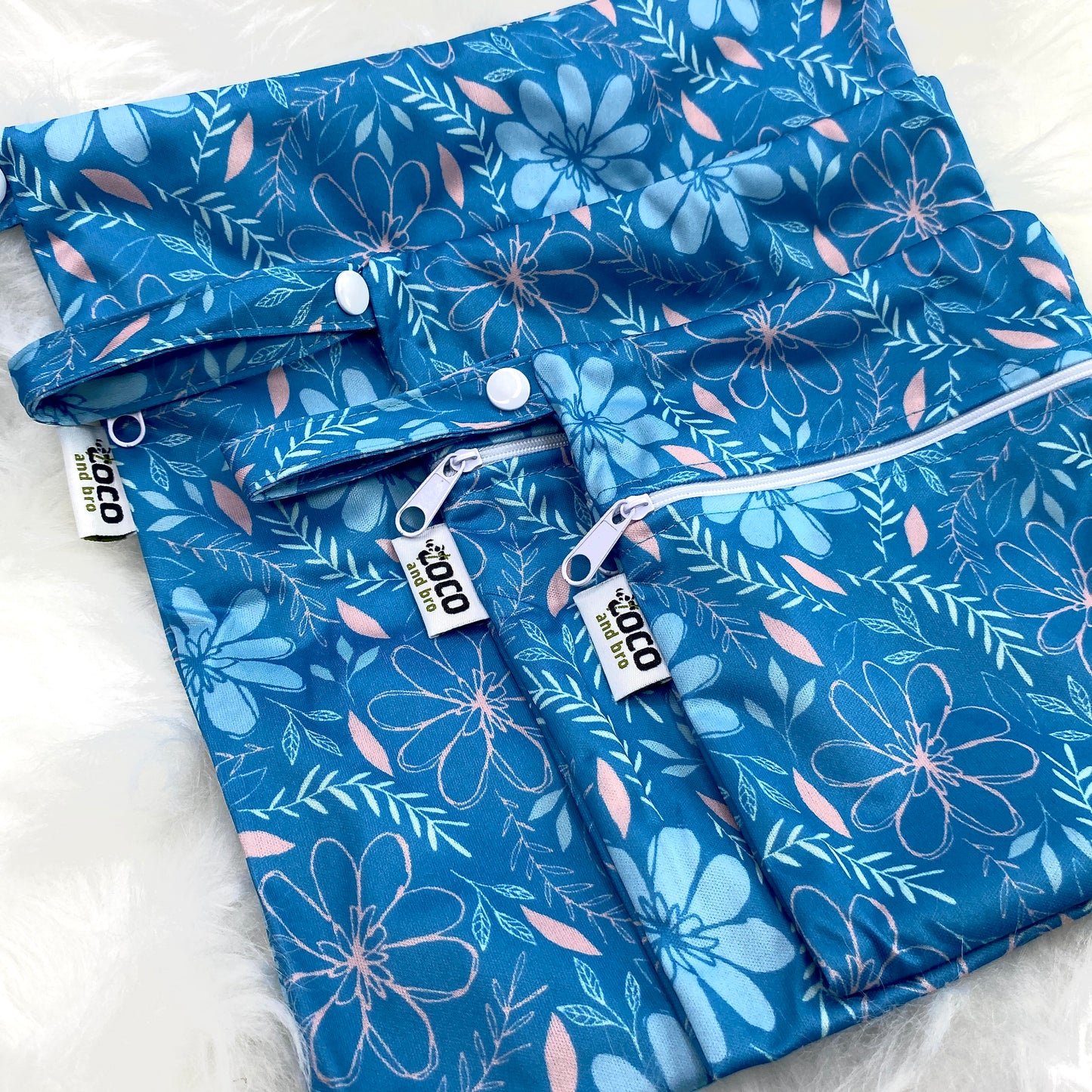 A set of three waterproof bags in a blue floral design, made from bamboo and in three different sizes. Each bag has a zipper closure.