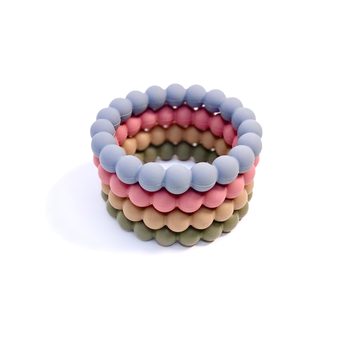 A range of beaded silicone teething rings, in green, beige, blue and pink.