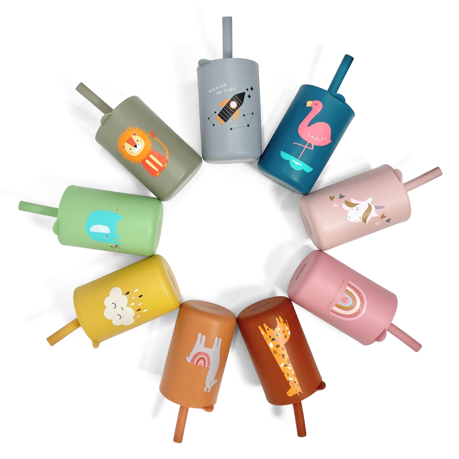 A collection of children’s silicone drinking cups with matching lids and straws, in various colours and designs, laid out in a circular pattern.
