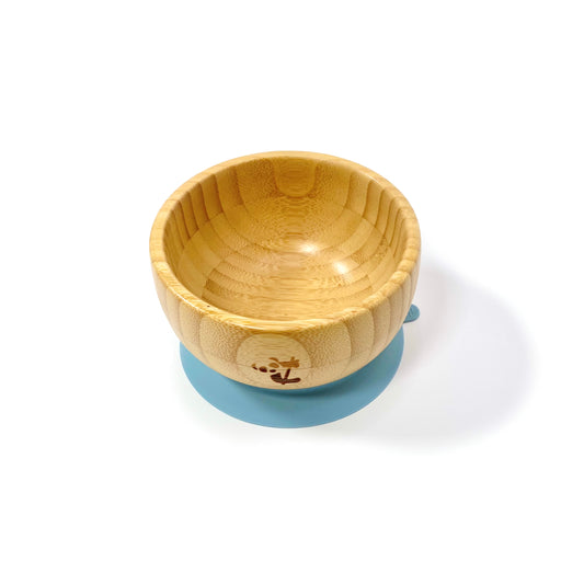 A children’s bamboo bowl with a sky blue silicone suction ring.