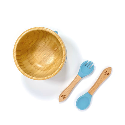A children’s bamboo bowl with a sky blue silicone suction ring, and matching sky blue silicone and bamboo cutlery.
