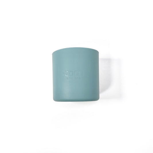 A sky blue silicone children’s drinking cup. Side view.