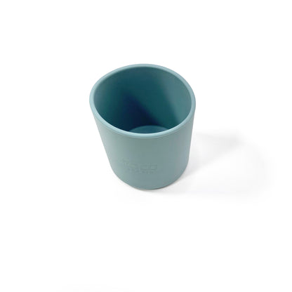 A sky blue silicone children’s drinking cup. View from above.