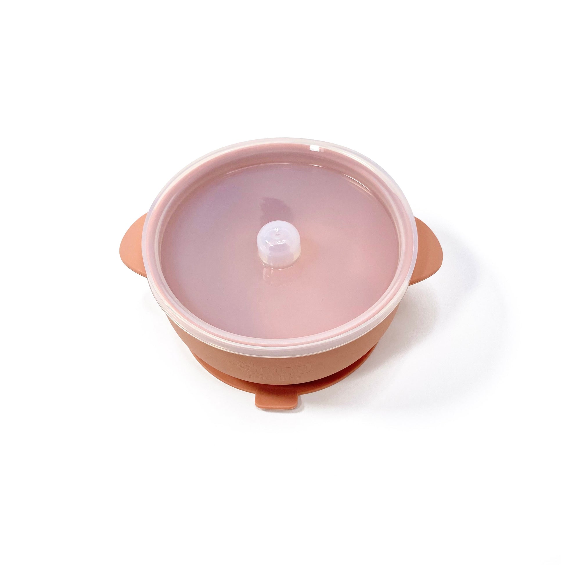 A sunset orange silicone children’s feeding bowl, with lid and suction cup. Image shows the bowl with lid attached.