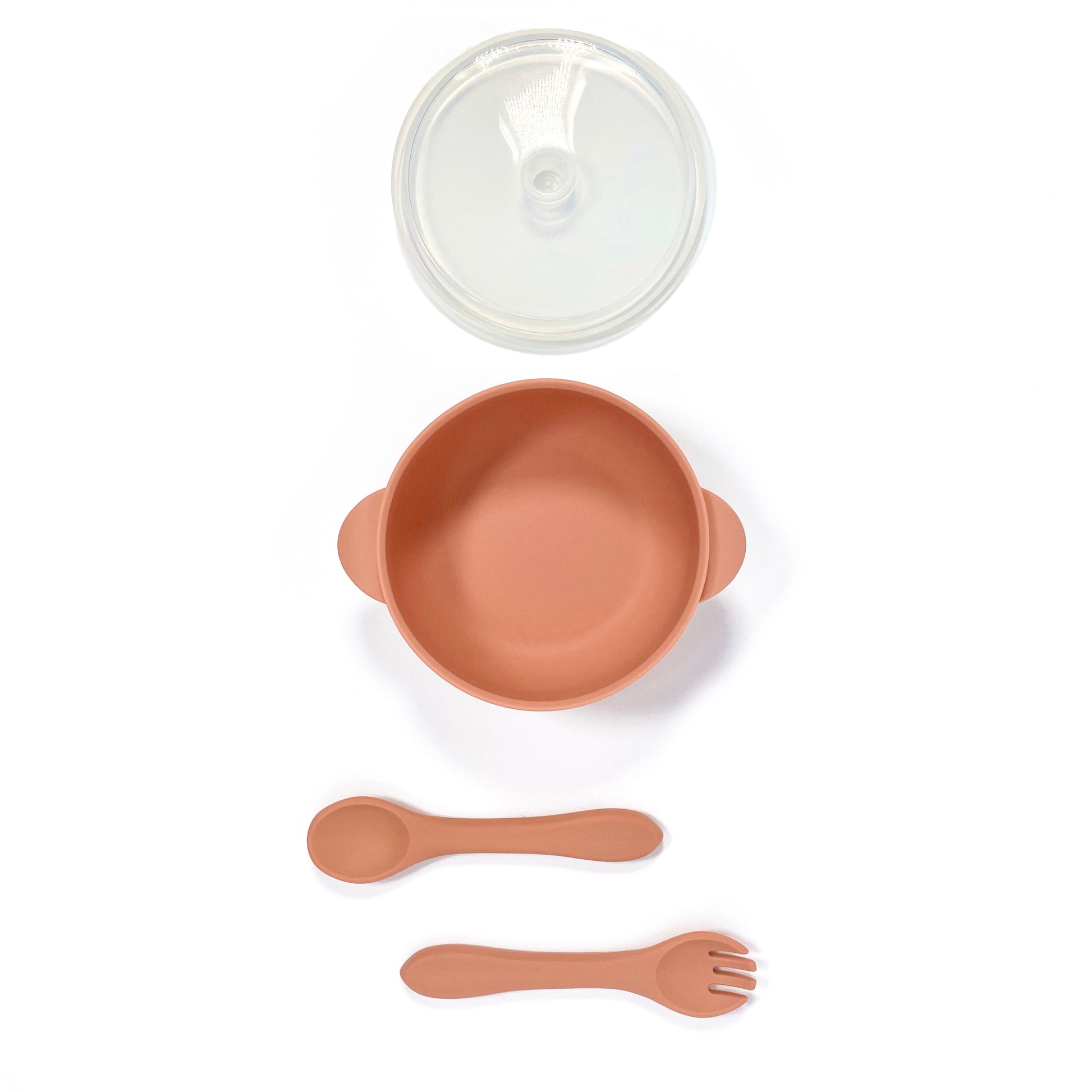 A sunset orange silicone children’s feeding set, including silicone bowl with lid and matching silicone cutlery. Image shows the bowl, lid and cutlery separately, from above.