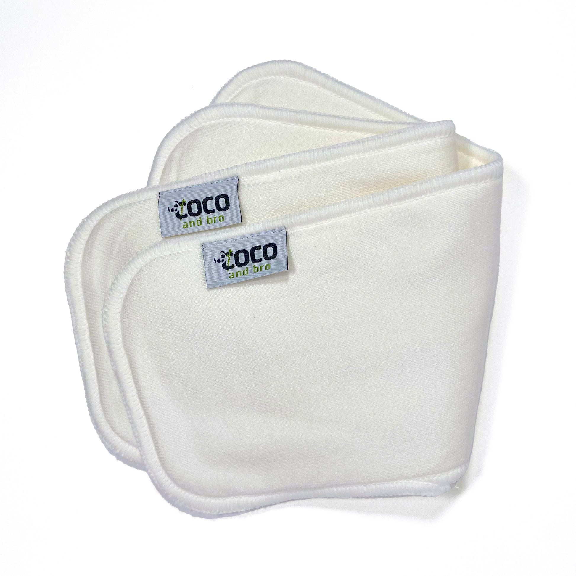 Image shows two nappy inserts made from a blend of two layers of luxuriously soft bamboo fibres and two layers of ultra-absorbent microfibre. Image shows the nappy inserts folded over as a pair.