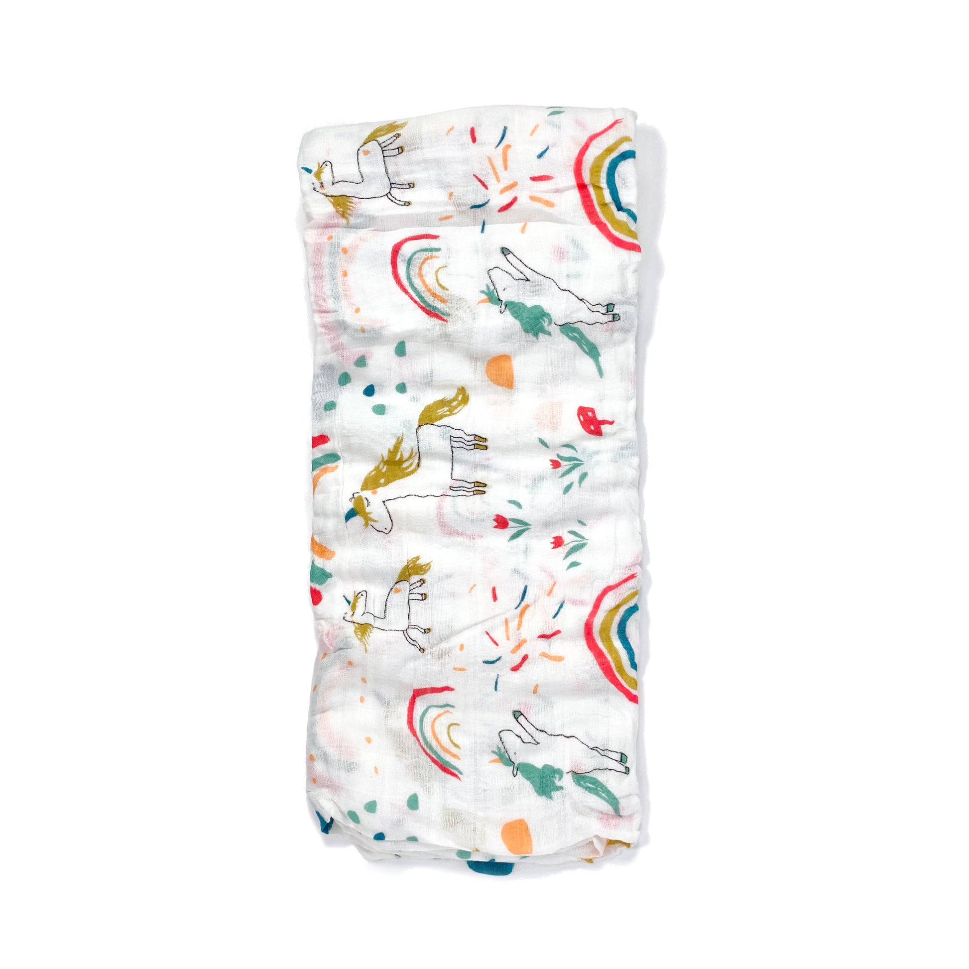 A folded muslin swaddle blanket with a unicorn design.