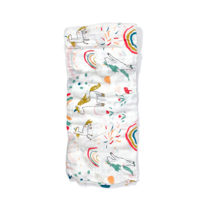 A folded muslin swaddle blanket with a unicorn design.