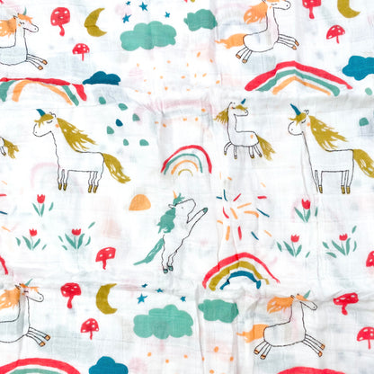 Close up pattern of a muslin swaddle blanket with a unicorn design.