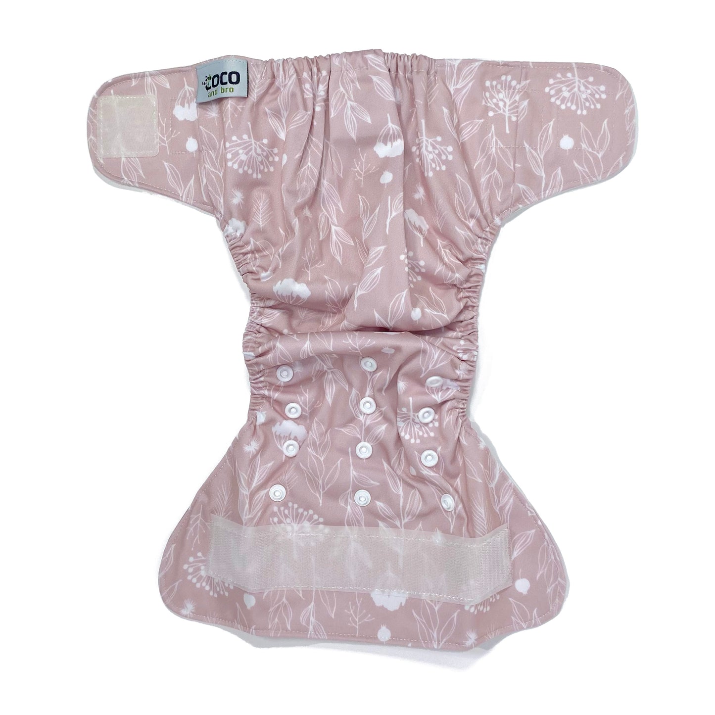 An adjustable reusable nappy for babies and toddlers, featuring a floral lilac design, with floral images on a lilac background. View shows the full outside pattern of the nappy, with fastenings open.