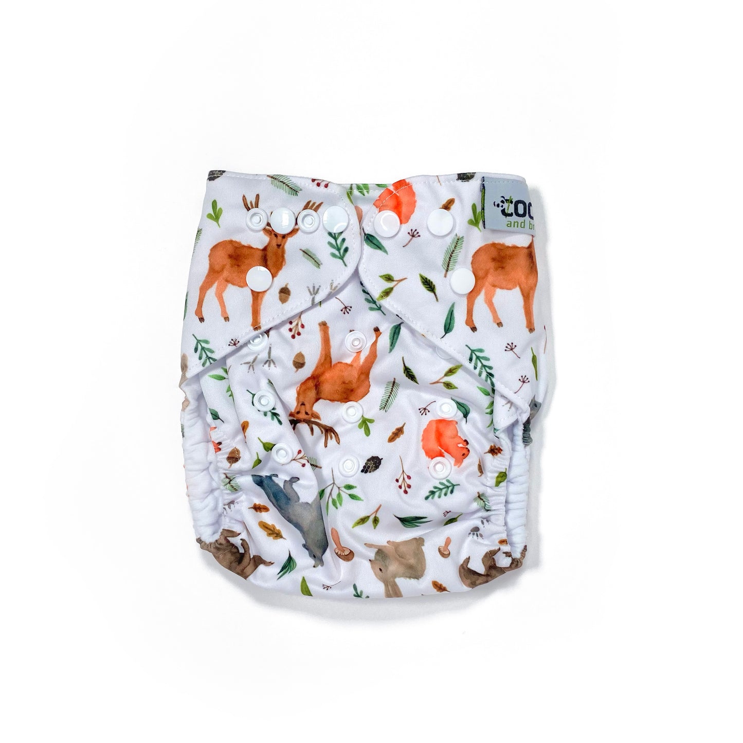An adjustable reusable nappy for babies and toddlers, featuring a woodland animal design, with images of various woodland animals on a white background. View shows the front of the nappy, with fastenings closed.
