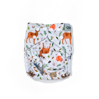 An adjustable reusable nappy for babies and toddlers, featuring a woodland animal design, with images of various woodland animals on a white background. View shows the front of the nappy. 