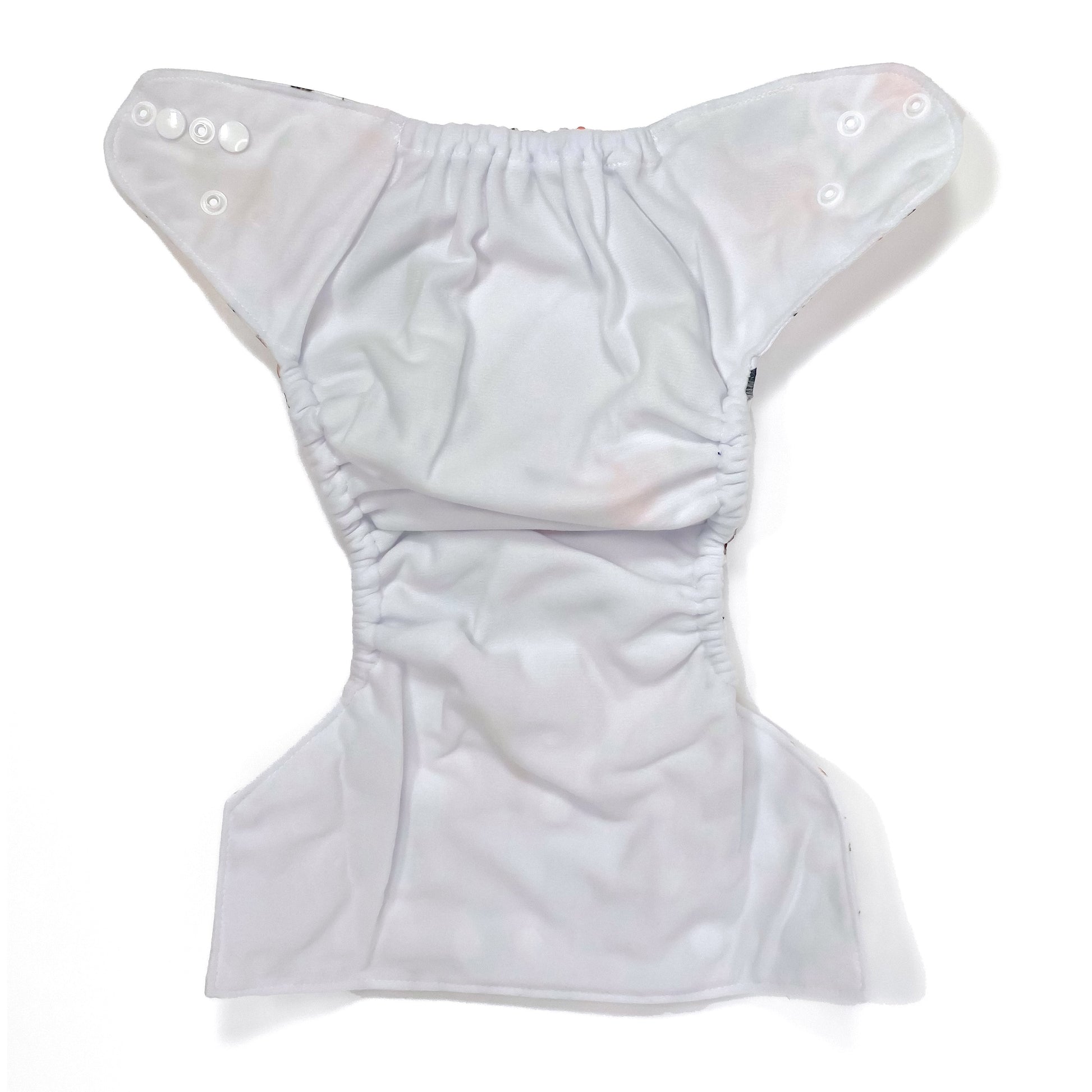 An adjustable reusable nappy for babies and toddlers, featuring a woodland animal design, with images of various woodland animals on a white background. View shows the inside fabric of the nappy.