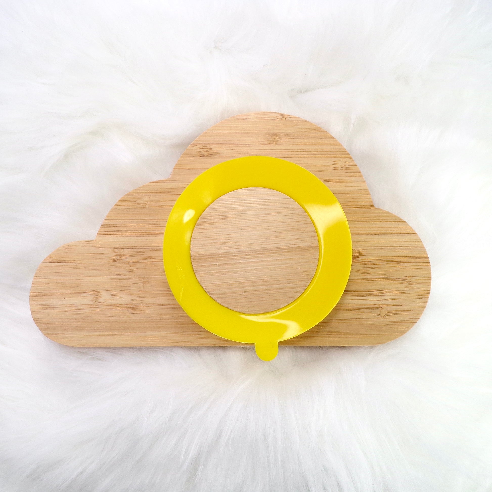 A children's bamboo section plate with a cloud design, yellow colour silicone suction ring and matching yellow bamboo and silicone cutlery. Back view.