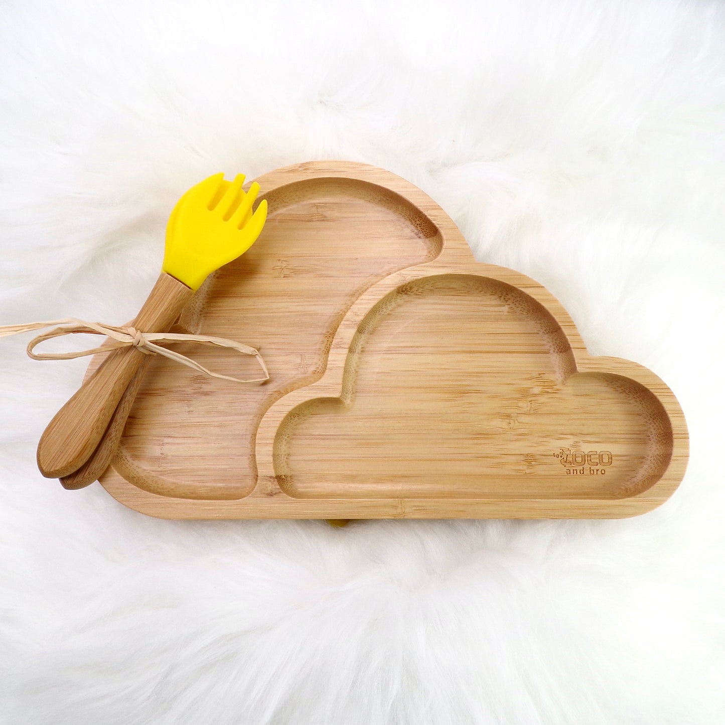A children's bamboo section plate with a cloud design, yellow colour silicone suction ring and matching yellow bamboo and silicone cutlery. Front view.