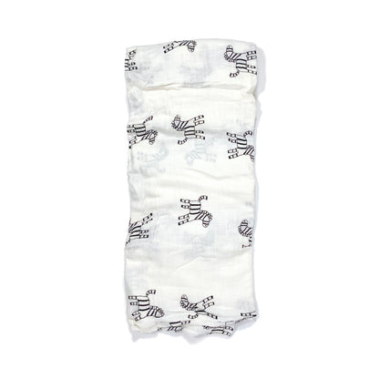 A folded muslin swaddle blanket with a zebra design.