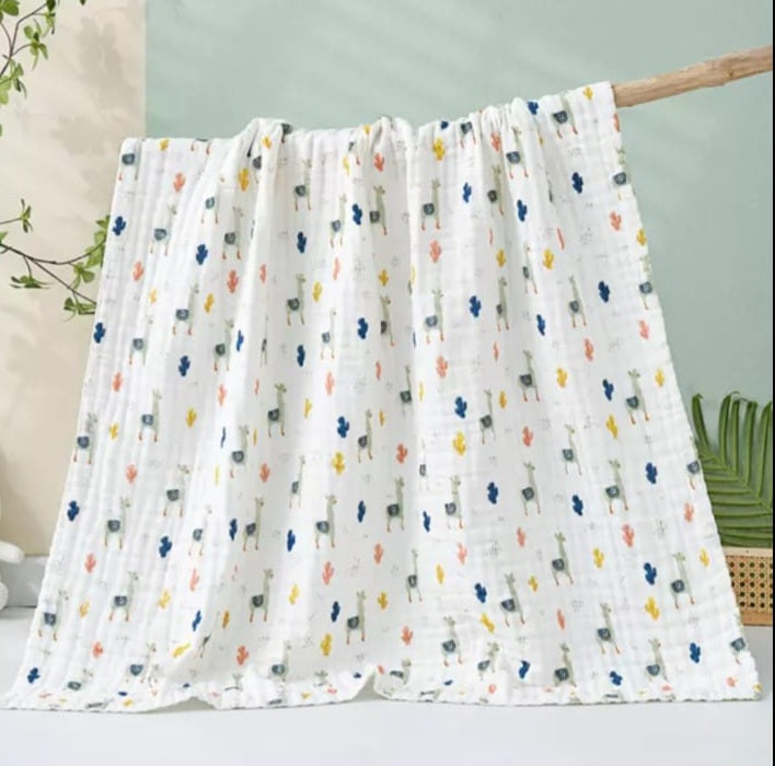 A large muslin baby blanket, made from bamboo and cotton fibres. This blanket is perfect for a baby nursery or out and about in a buggy. The blanket features a llama pattern.