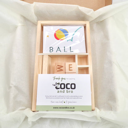 A children's wooden alphabet blocks spelling toy, with wooden letter blocks and spelling cards.