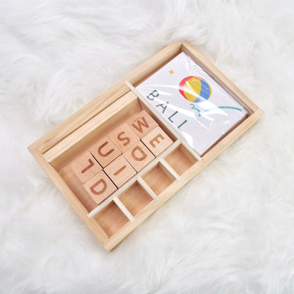 A children's wooden alphabet blocks spelling toy, with wooden letter blocks and spelling cards.