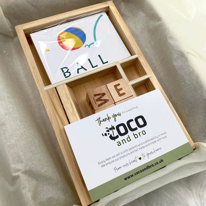 A children's wooden alphabet blocks spelling toy, with wooden letter blocks and spelling cards.