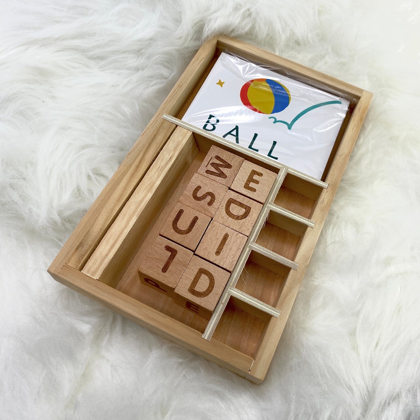 A children's wooden alphabet blocks spelling toy, with wooden letter blocks and spelling cards.