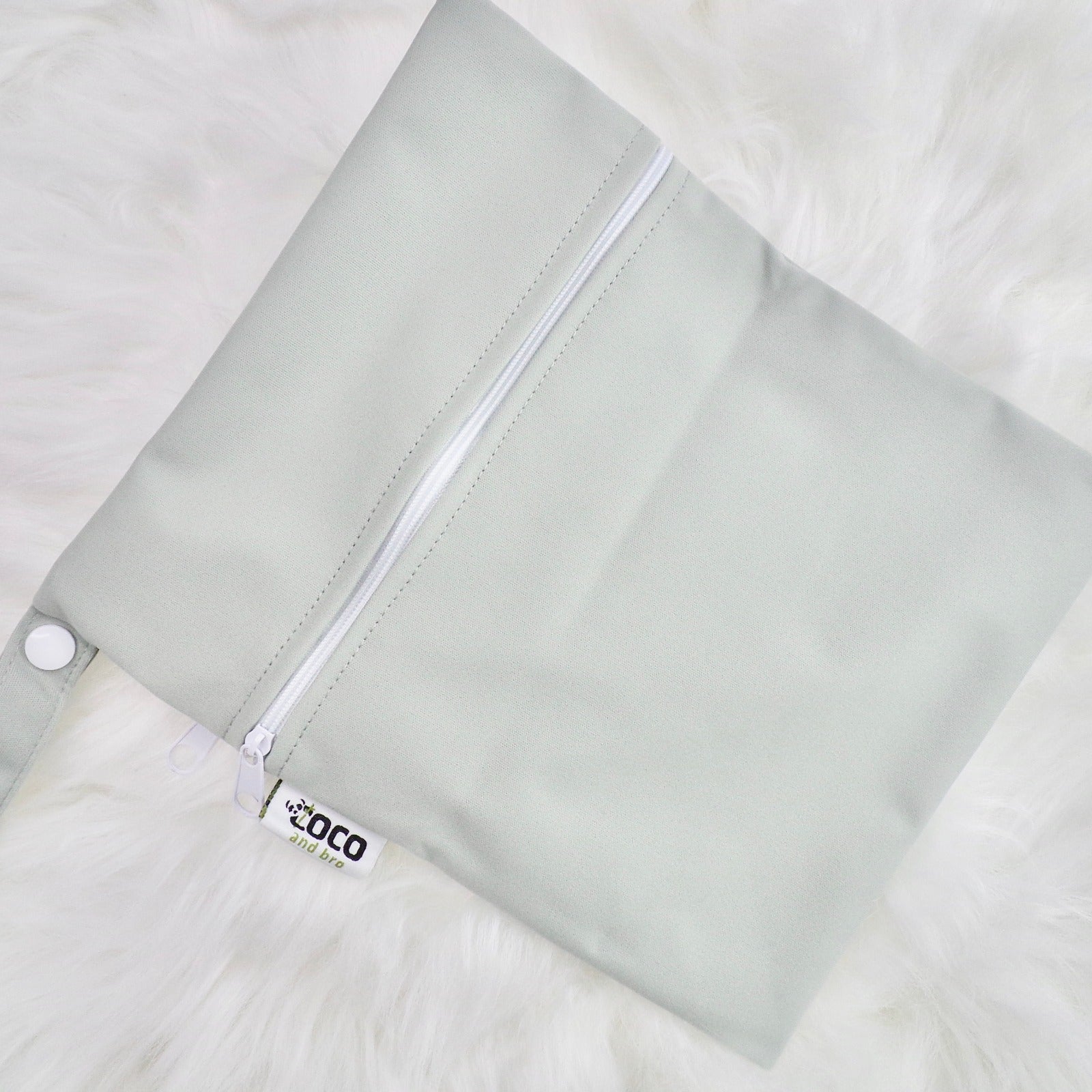 Each backpack purchase includes a free waterproof bag. This image shows the waterproof bag in grey, with a zip closure.