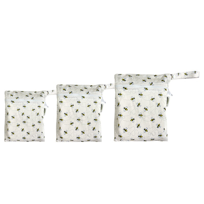 A set of three waterproof bags in an off-white bumble bee design, made from bamboo and in three different sizes. Each bag has a zipper closure.