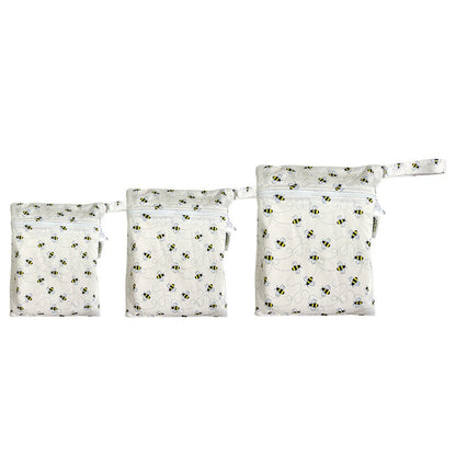 A set of three waterproof bags in an off-white bumble bee design, made from bamboo and in three different sizes. Each bag has a zipper closure.