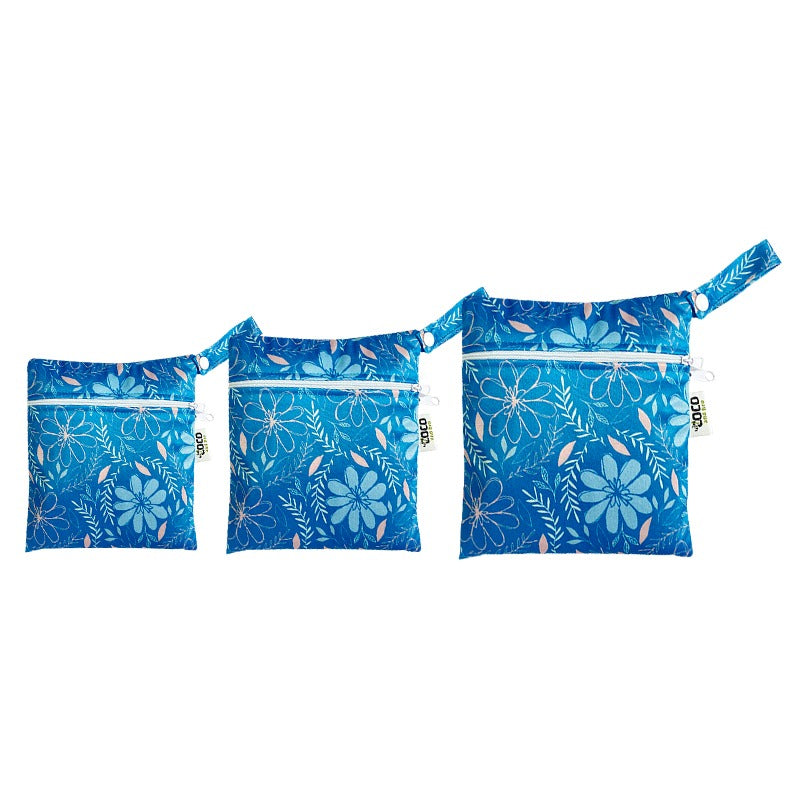 A set of three waterproof bags in a blue floral design, made from bamboo and in three different sizes. Each bag has a zipper closure.