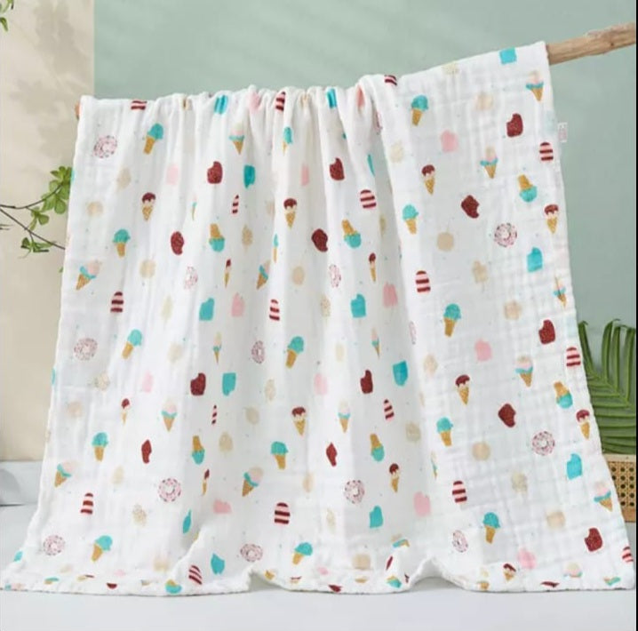 A large muslin baby blanket, made from bamboo and cotton fibres. This blanket is perfect for a baby nursery or out and about in a buggy. The blanket features a cute ice cream pattern.