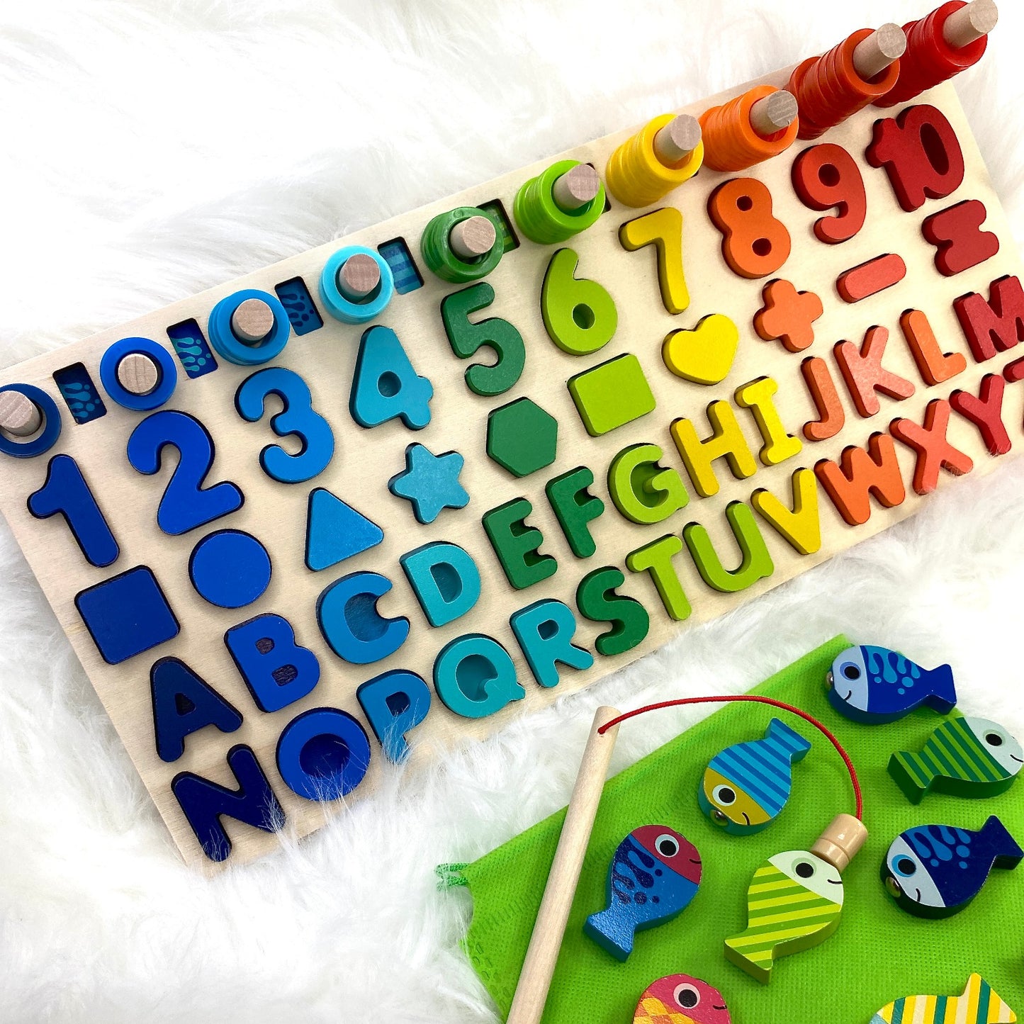 A multifunctional children’s wooden puzzle toy, featuring colourful shapes, numbers, counting rings and a magnetic fish game.
