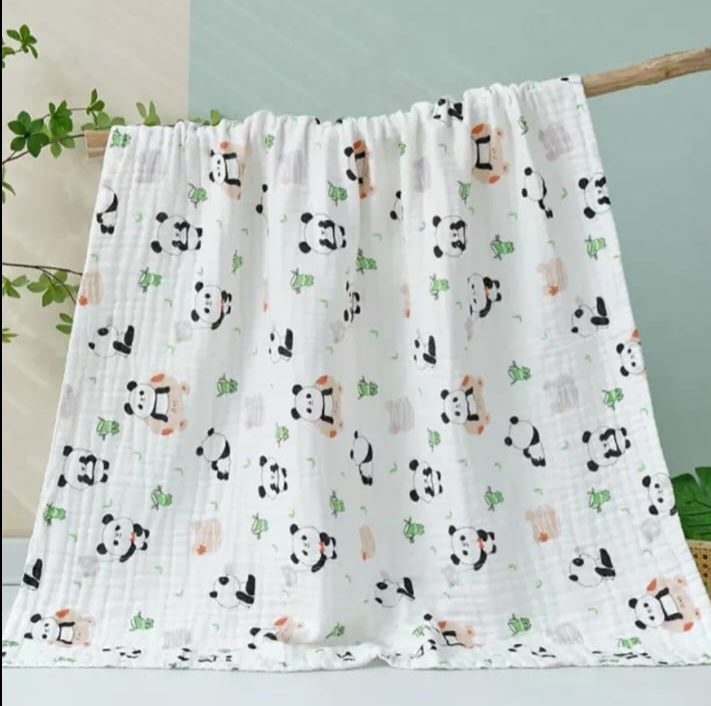 A large muslin baby blanket, made from bamboo and cotton fibres. This blanket is perfect for a baby nursery or out and about in a buggy. The blanket features a cute panda pattern.
