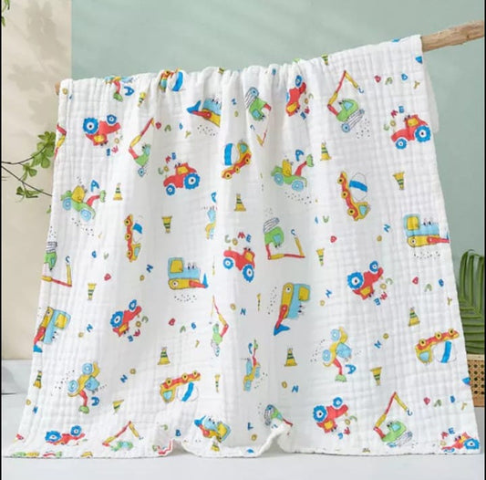 A large muslin baby blanket, made from bamboo and cotton fibres. This blanket is perfect for a baby nursery or out and about in a buggy. The blanket features a cute tractor pattern.